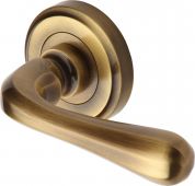 V3020-AT Heritage Brass Door Handle Lever Latch on Round Rose Charlbury Design Antique Brass Finish